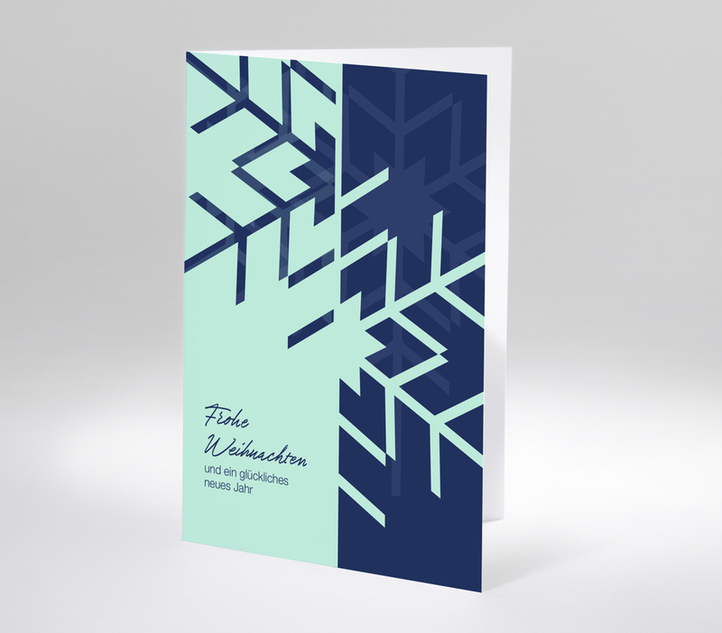 Moderne Weihnachtskarte mit grafischen Schneeflocken in Blau und Mint