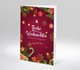 Festlich dekorierte Weihnachtskarte mit rotem Hintergrund, Tannenzweigen, Kugeln, Schneeflocken und dem Schriftzug Frohe Weihnachten und ein gutes neues Jahr